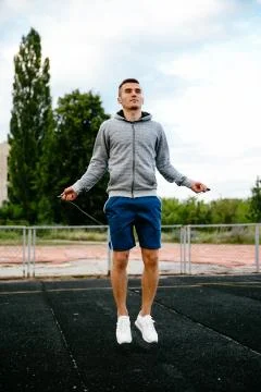 Jumping guy with skipping rope Stock Photos