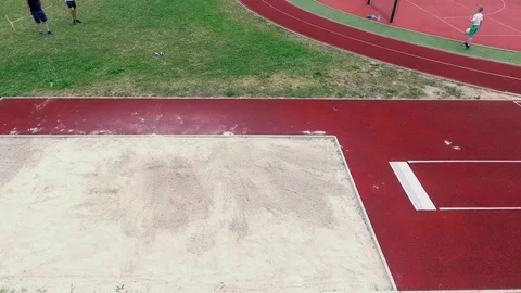 Jumping high up and then performing a long jump Video stock 84006668