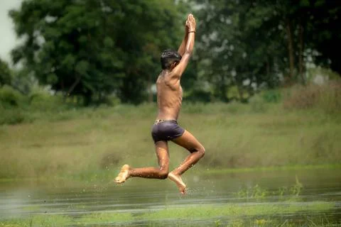 Jumping kid over the water Stock Photos