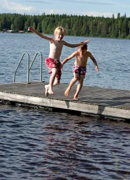 Jumping in a lake Stock Photos