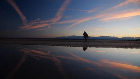 Jumping man making first steps in desert during breathtaken sunset. Stock Footage 117224669