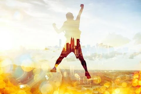 Jumping Man on the peak with panoramic view contemporary city double exposure Stock Photos