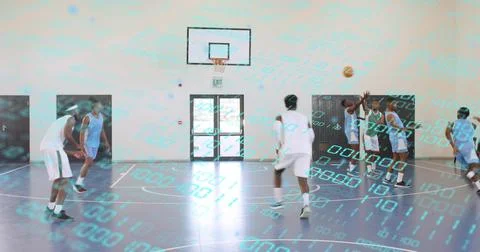 Jumping players in white jerseys contesting shot near right hoop on gym court Stock Photos