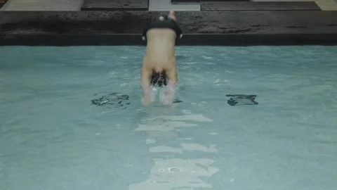Jumping Into Pool in Hotel, High Angle, Slo-Mo Stock Footage 132987140