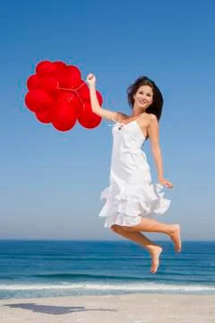 Jumping with red ballons Stock Photos