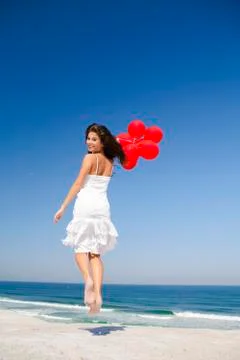 Jumping with red ballons Stock Photos