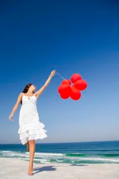 Jumping with red ballons Stock Photos