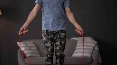 Jumping rope. Warming up before training. a young sportsman is engaged in Stock Footage 159222568