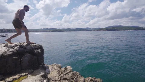 Jumping into the sea in slow motion Stock Footage 212507408