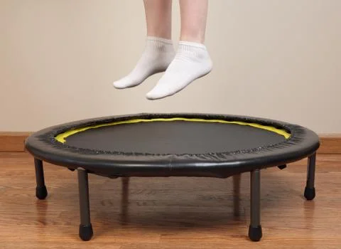 Jumping on small trampoline Stock Photos