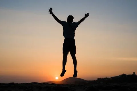 Jumping up at Sunset Stock Photos