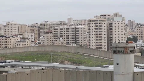 Jumping the wall, the only way out for Palestinians without a work permit since  Stock Footage 328428092
