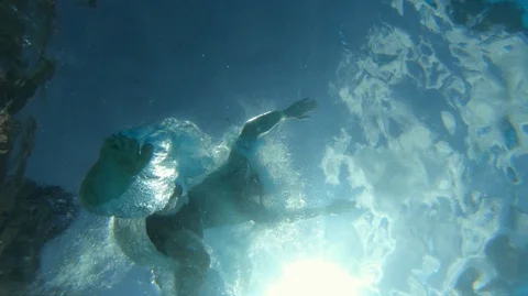 Jumping in water, slow motion shot at 100 fps, view from below Stock Footage 112663973