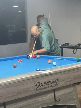 Jumpshot technique at pool table Stock Photos