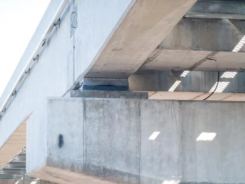 The junction between Head of a concrete bridge and the beam of the train tracks Fotos de archivo