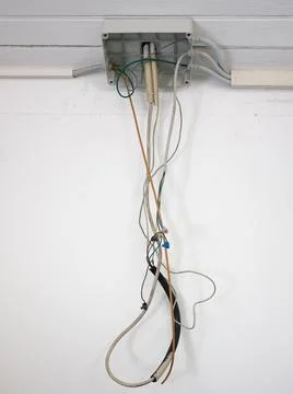 Junction box of an open electrical system with dangling wires Stock Photos