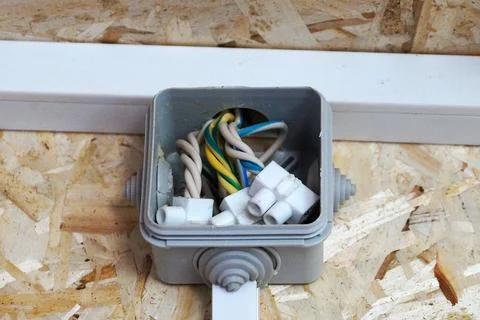 Junction box on the wall made of OSB plywood Stock Photos