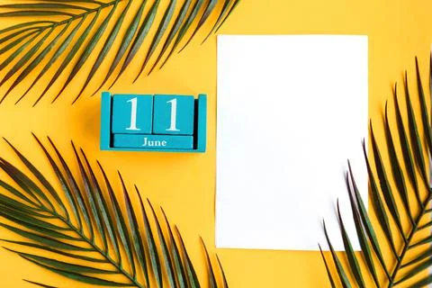 June 11. Blue cube calendar with month date isolated on yellow background Stock Photos