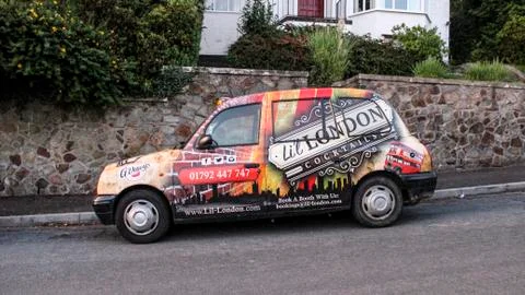 June 2019, Swansea, Wales. Lil London Cocktails Bar Advertised on a black cab Stock Photos
