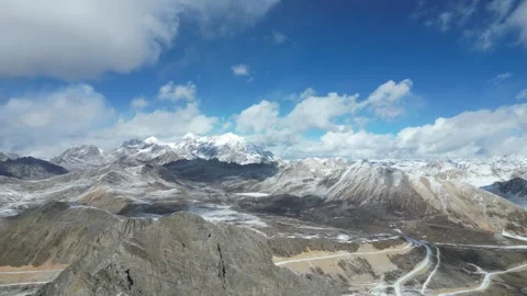 On June 23, 2025:Continuous snow-capped mountains and highways in Tibet Stock Footage 318734693