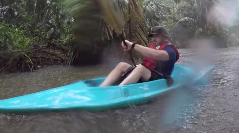 Jungle kayaking in rain Stock Footage 63503668
