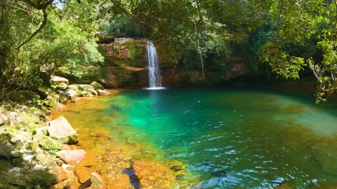 Jungle waterfall with white waters running down Rocky ridge of hill to blue.. Video stock 271171066