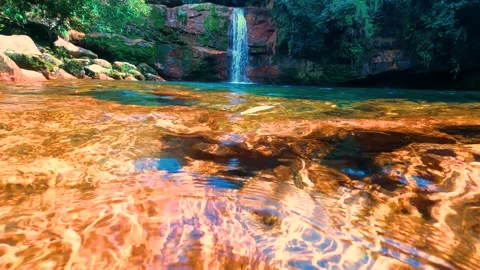 Jungle waterfall with white waters running down Rocky ridge of hill to blue.. Stock Footage 271171429