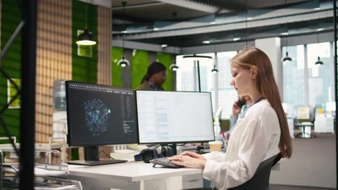 Junior developer optimizing performance using AI LLM chatbot Stock Footage 313016055