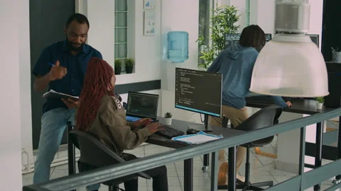 Junior developer working on terminal window to code system script Stock Footage 217408686