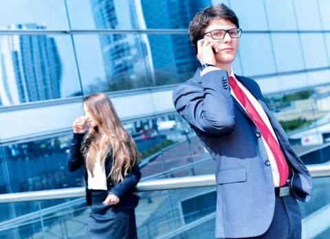 Junior executive dynamic phoning outside of his office Stock Photos