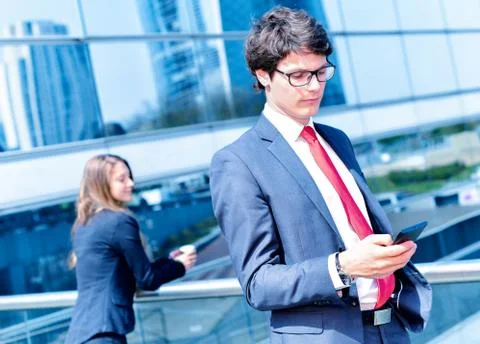 Junior executive dynamic phoning outside of his office Stock Photos