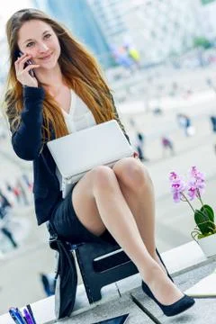 Junior executive dynamic phoning outside of her office Stock Photos
