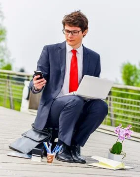 Junior executive dynamic working outside of his office Stock Photos