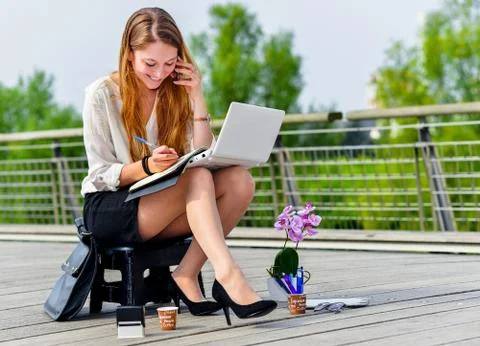 Junior executive dynamic working outside of her office Stock Photos