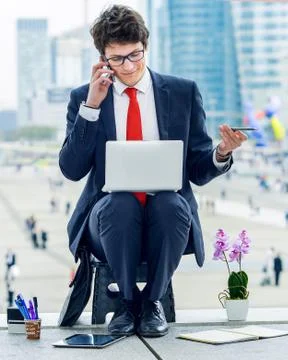 Junior executive dynamic working outside of his office Stock Photos