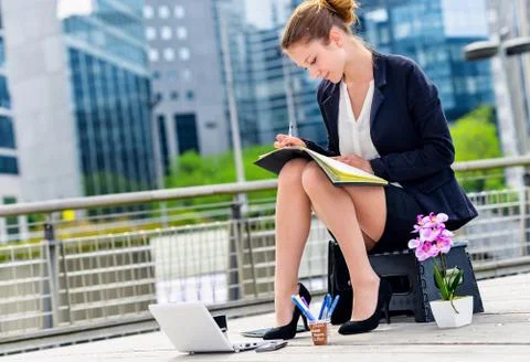Junior executive dynamic working outside of her office Stock Photos