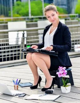 Junior executive dynamic working outside of her office Stock Photos