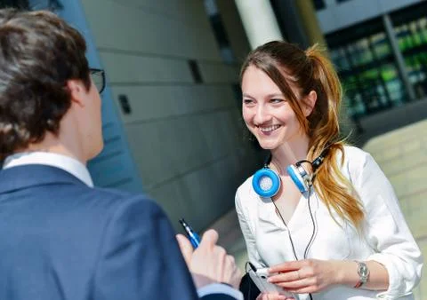 Junior executives having a coffee break in front of their company Stock Photos