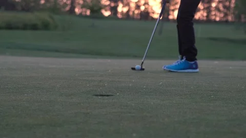 Junior golf player is putting off a ball from hole Stock Footage 95120309