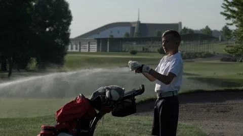 Junior golfer playing golf on summer with hitting shot on green grass Stock Footage 95127789