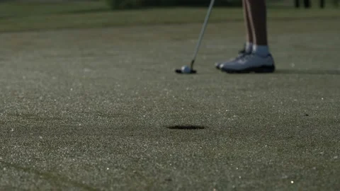 Junior golfer playing golf on summer with hitting shot on green grass Stock Footage 95129214