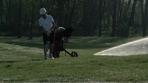 Junior golfer playing golf on summer with hitting shot on green grass Stock Footage 95134035