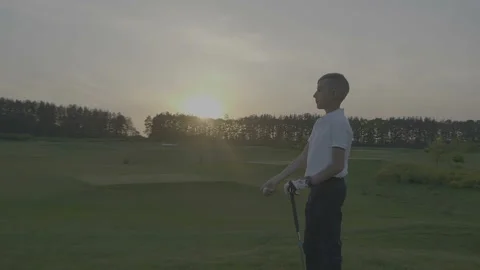 Junior Golfing Into Sunset. Stock Footage 95123561