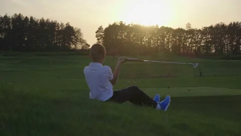 Junior Golfing Into Sunset. Stock Footage 95126196