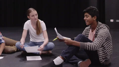 Junior high students and teacher rehearsing script on theater stage Video stock 220945699