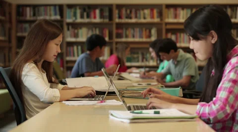 Junior high students studying in library Stock Footage