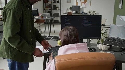 Junior Male Developer Showing Code on Tablet to Strict Female Supervisor Stock Footage 335941380