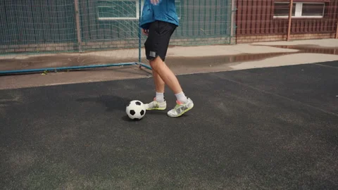 Junior player performing footwork drills near goal post, Youthful individual Stock Footage 337654234