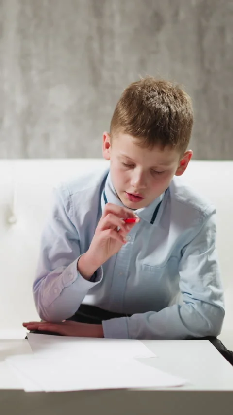 Junior schoolchildren do homework sitting in living room Stock Footage 309892797