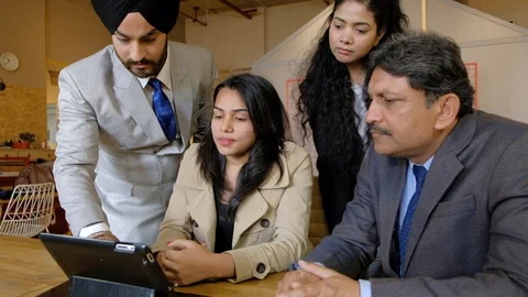 Junior trying to impress his senior boss and coworkers using a smart touchscreen Stock Footage 104586445